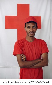 Hindu Man Volunteer Stands In A Red Shirt.