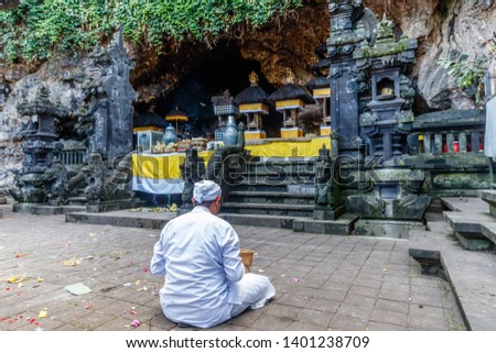Hindu priest praying at Pura Goa Lawah (