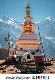 a hindu temple, called stupa, in front of the massive Himalaya mountain range summits full of snow