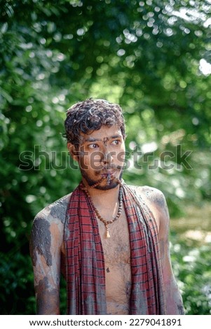 Hindu young devotee painted his body and faces with mud and colours in Durgapuja festival