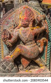 Hinduist sculpture covered in color powder at the Bagh Bhairab temple in Kirtipur, Nepal