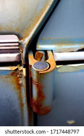 Hinge of an old vehicle door with some rust showing.