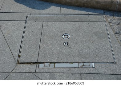 a hinged hatch with a patent lock to the underground of the city, where there are collector shafts with engineering networks. or the facility and subway entrance directly from the sidewalk - Shutterstock ID 2186958503