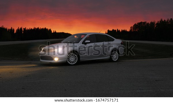  Hinton, AB / Canada - 3/16/20: Sports Car On\
Highway With Sunrise\
Background