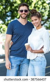 Hip Couple Smiling At The Camera In The City