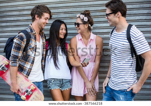 Hip Friends Looking Smartphone Leaning Against Stock Photo Edit