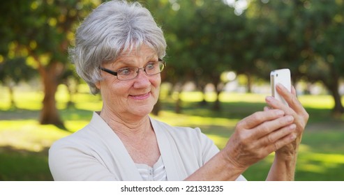 Hip Grandma Taking Selfies At The Park