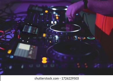 Hip hop dj plays music.Disc jockey mixing musical tracks with turntables and sound mixer on concert.Professional audio equipment on festival stage