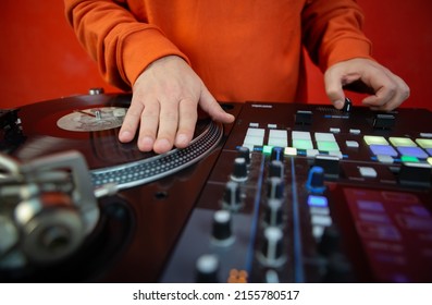 Hip Hop Dj Scratching Vinyl Record On Turntables. Disc Jockey Playing Music On Party In Night Club. Professional DJ Scratches Records With Turn Table Player And Sound Mixer