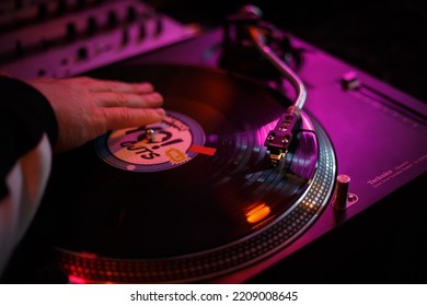 Hip Hop Dj Scratching Vinyl Record With Music On Party In Night Club. Disc Jockey Scratches Disc In Turn Table. Disk Jokey Mixing Musical Tracks On Turntables In Nightclub. KYIV - 1 OCTOBER, 2022