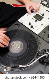 Hip Hop DJ Scratching Vinyl Record On Turntable And Sound Mixer. Overhead Shot