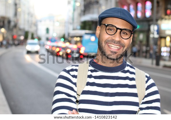 Hip man smiling in urban\
background