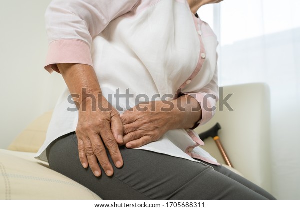 Hip pain of senior woman at home, healthcare\
problem of senior concept