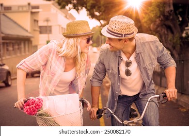 Hip Young Couple Going For A Bike Ride On A Sunny Day In The City