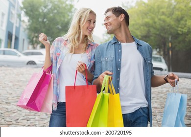 Hip Young Couple On Shopping Trip On A Sunny Day In The City