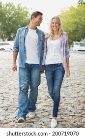 Hip Young Couple Walking Holding Hands On A Sunny Day In The City