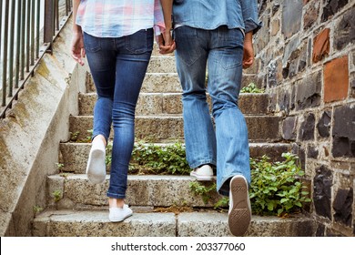 Hip Young Couple Walking Up Steps On A Sunny Day In The City