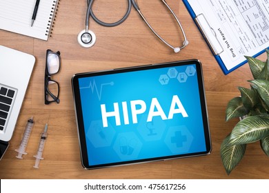 HIPAA Professional doctor use computer and medical equipment all around, desktop top view