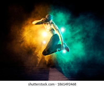 Hip-hop dance party. Young man break dancing on smoke background - Powered by Shutterstock