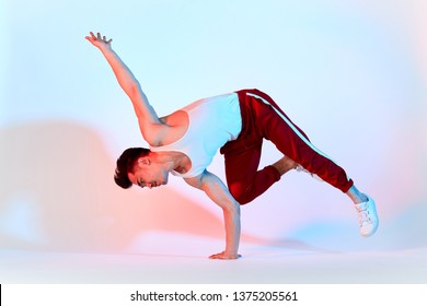 Hip-hop Korean Break Dancer In Red Sweat Pants Stay In White Classroom All Day And Learn Choreography Done By Other People, Working Out Over Technique. BBoy Doing Chair Classic Freeze