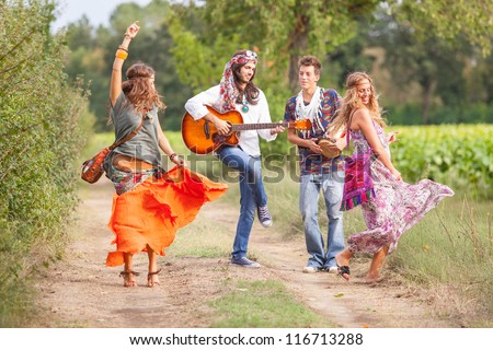 Hippie Group Playing Music and Dancing Outside