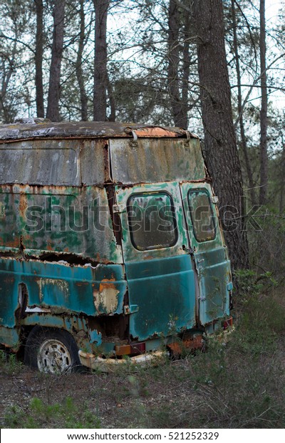 Hippie old van abandoned in\
forest
