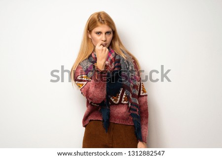 Hippie woman over white wall with angry gesture
