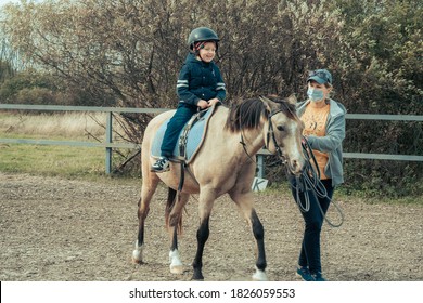 Hippotherapy for young children is the prevention many serious diseases. Concept of spring and summer sports, care, good mood, horse trainings; equistrain club; hippotherapy; vacation and hobby - Powered by Shutterstock