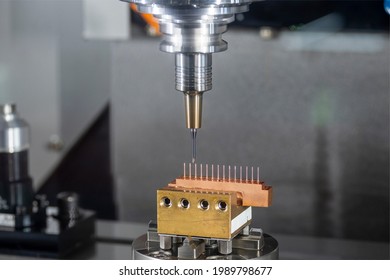 The   hi-precision CNC milling machine cutting the copper electrode material and G-code data background. The electrode cutting process  by machining center.