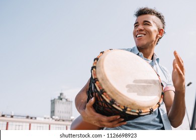 Hipster African American Street Drummer Performing Outdoors