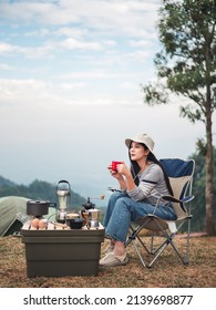 Hipster Asian Woman Camper Relaxing And Enjoying Camping Alone ,drinking Coffee In The Morning