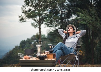 Hipster Asian Woman Camper Relaxing And Enjoying Camping Alone On Vacation.