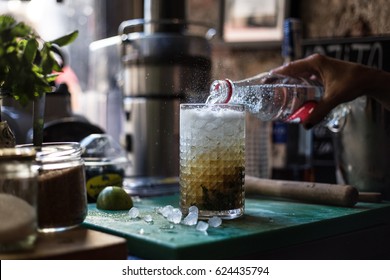 Hipster Bartender Mixologist Creates Summer Fresh Mojito Cocktail With Mint Lemon Lime Soda Bubbles In Artisanal Bar Full Of Atmosphere