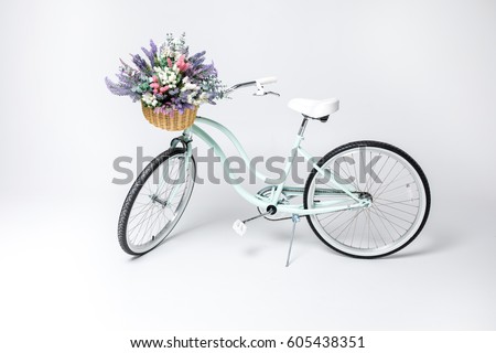  Hipster bicycle with basket full of fresh flowers  isolated on white