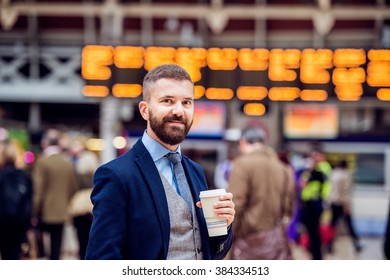 Hipster businessman with coffee cup at the train station - Powered by Shutterstock