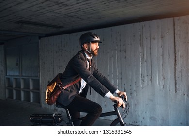 Hipster Businessman Commuter With Electric Bicycle Traveling To Work In City.