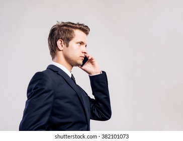 Hipster Businessman With Smartphone Making Phone Call. Studio Sh