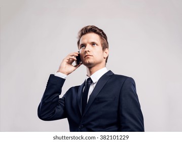 Hipster Businessman With Smartphone Making Phone Call. Studio Sh