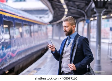 Hipster businessman with smartphone, waiting at the train platfo - Powered by Shutterstock