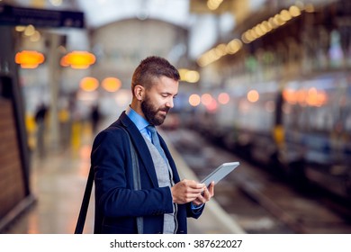 Hipster businessman with tablet, waiting, train platform - Powered by Shutterstock