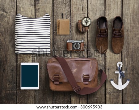 hipster clothes and accessories on a wooden background