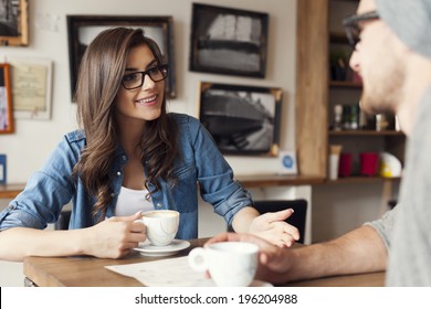 Hipster Couple Talking At Cafe 