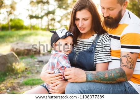 Hipster family, bearded dad with tattoos and stylish clothes.