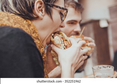 Hipster Friends In Fast Food Reastaurant Eating Burgers