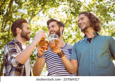 Hipster friends having a beer together on a summers day - Powered by Shutterstock