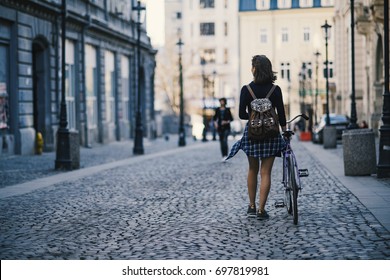 Hipster Girl With A Bike Walking On The Street