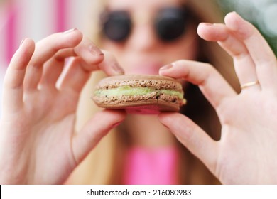 Hipster Girl In A Cafe Eating Macaroon. 