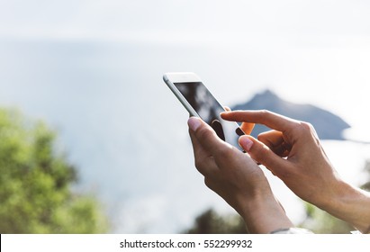 Hipster Girl Texting Message On Smartphone Mobile Close Up, View Tourist Hands Using Gadget Phone On Device On Background Perspective Mountains And Sky Landscape; Finger Touch Screen Cellphone Mockup