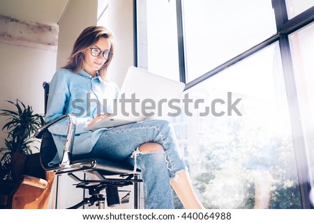 Hipster Girl use Laptop huge Loft Studio.Student Researching Process Work.Young Business Woman Working Creative Startup modern Office.Analyze market stock,new strategy.Blurred,film effect.Horizontal