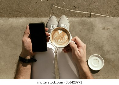 Hipster Guy Drinking Coffee And Using Cellphone.